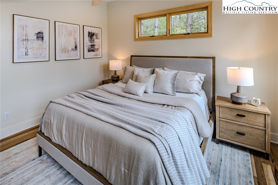 281 New Riv Farms Road Fleetwood, NC 28626 - Photo 25 of 50 a bed room with a bed and painting on the wall