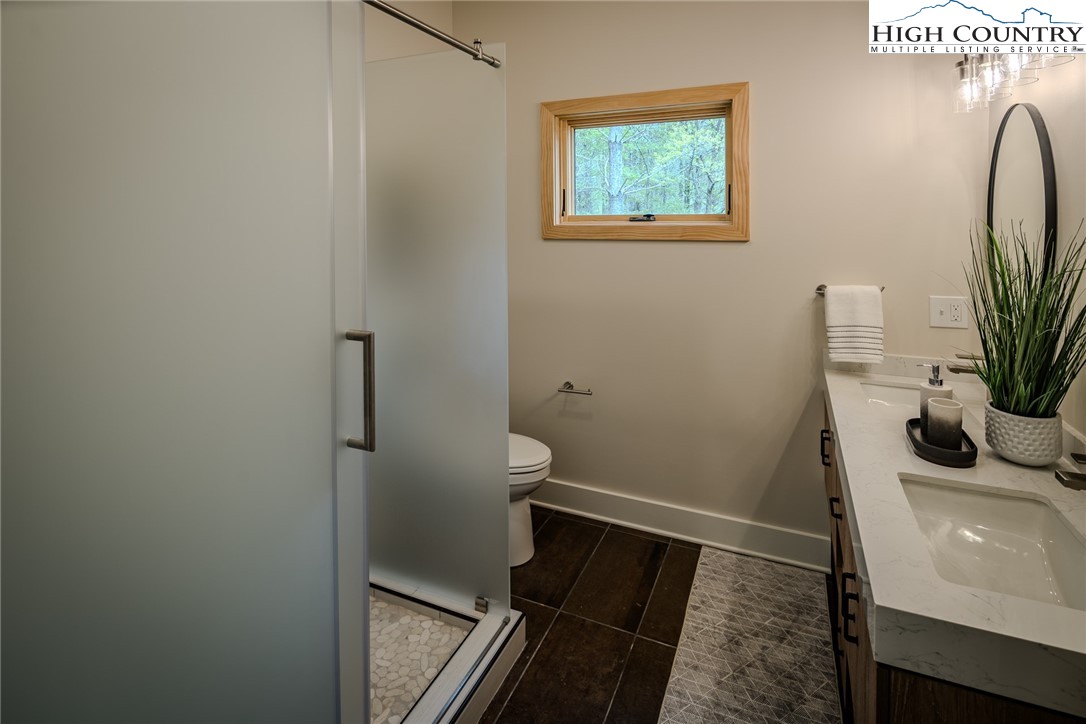 281 New Riv Farms Road Fleetwood, NC 28626 - Photo 27 of 50 a bathroom with a sink and a mirror