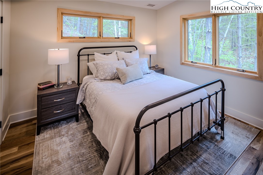 281 New Riv Farms Road Fleetwood, NC 28626 - Photo 30 of 50 a bedroom with a bed and a window