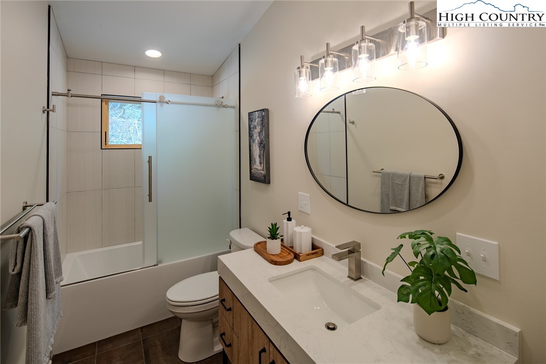 281 New Riv Farms Road Fleetwood, NC 28626 - Photo 33 of 50 a bathroom with a sink toilet and a mirror