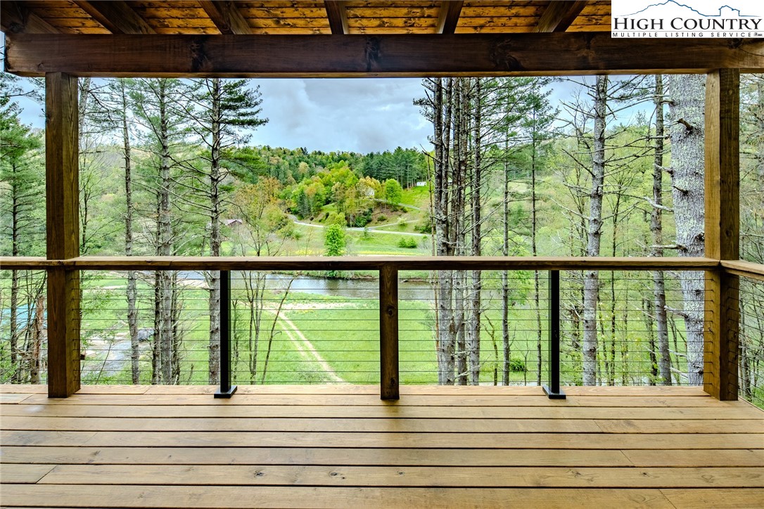 281 New Riv Farms Road Fleetwood, NC 28626 - Photo 35 of 50 a view of a balcony with lake view and a potted plant