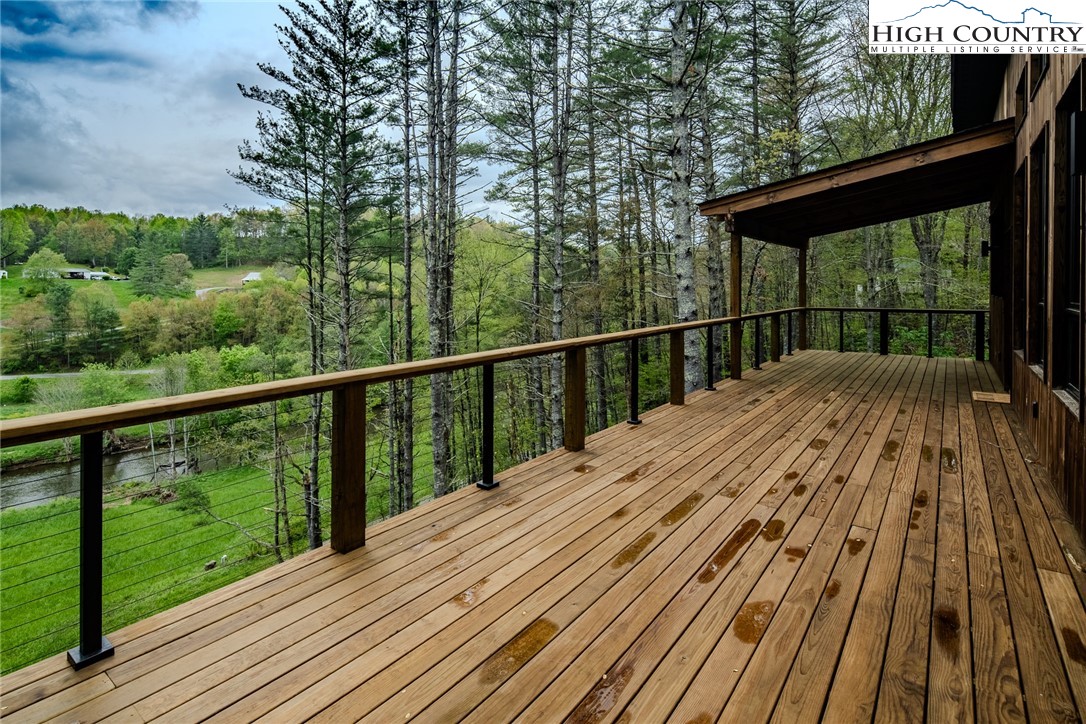 281 New Riv Farms Road Fleetwood, NC 28626 - Photo 41 of 50 a view of balcony with wooden floor and fence