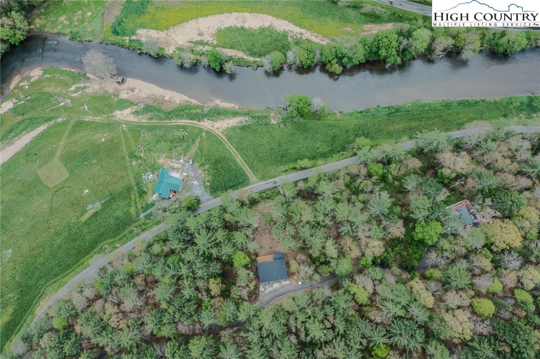 281 New Riv Farms Road Fleetwood, NC 28626 - Photo 48 of 50 an aerial view of residential houses with outdoor space and trees around