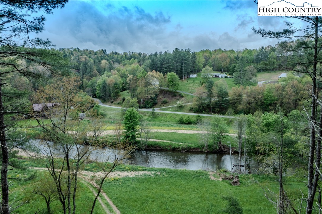 281 New Riv Farms Road Fleetwood, NC 28626 - Photo 50 of 50 a view of a garden with a lake