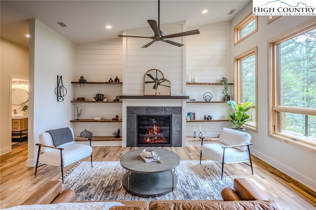 281 New Riv Farms Road Fleetwood, NC 28626 - Photo 7 of 50 a living room with furniture and a fireplace
