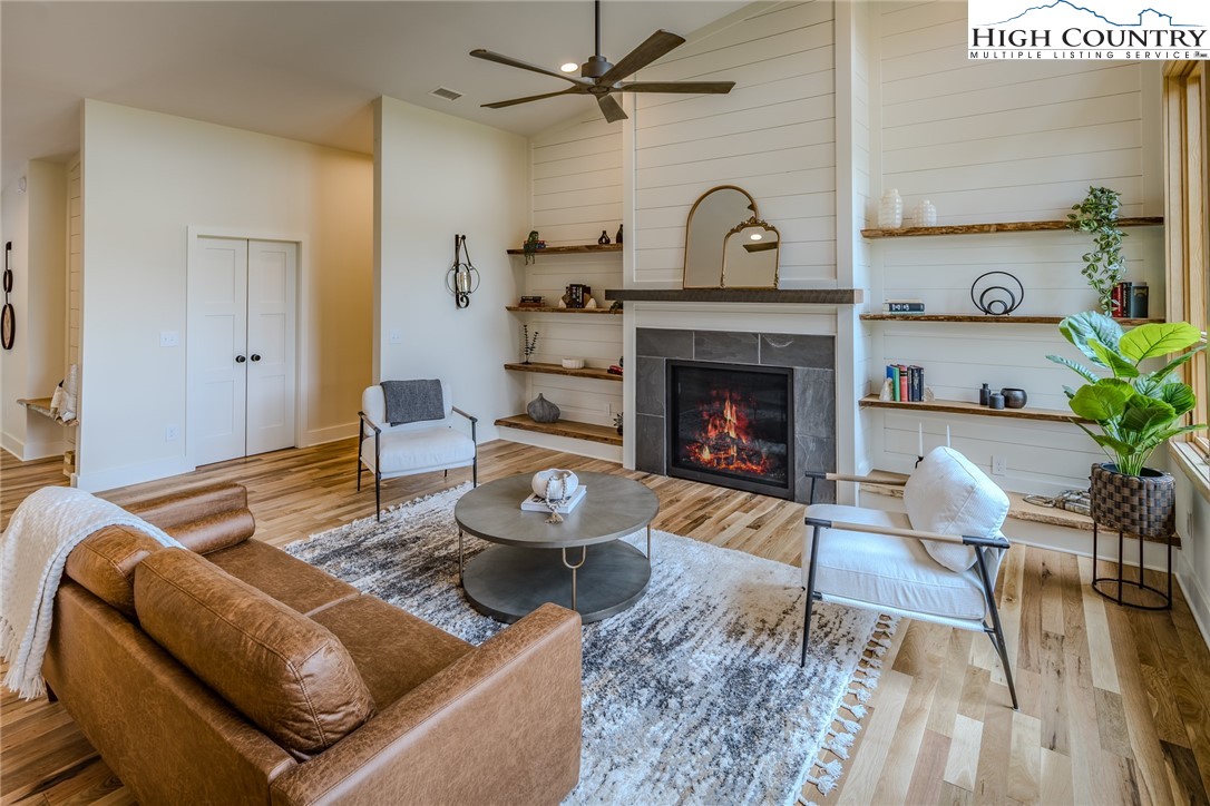 281 New Riv Farms Road Fleetwood, NC 28626 - Photo 8 of 50 a living room with furniture and a fireplace