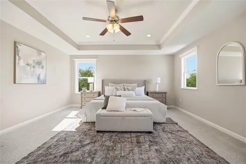 a spacious bedroom with a bed and a window