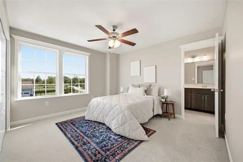 a bedroom with a large bed rug and a window