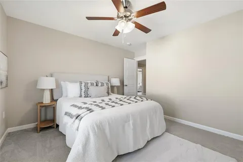 a bedroom with a bed and a ceiling fan