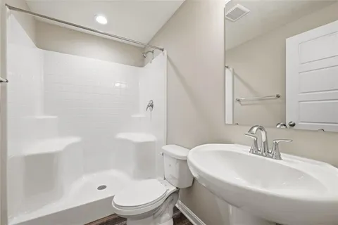 a bathroom with a sink toilet and shower