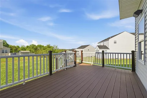 a view of a wooden deck with a yard