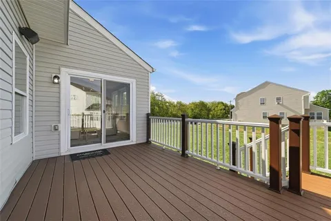 a view of a balcony with wooden floor and fence
