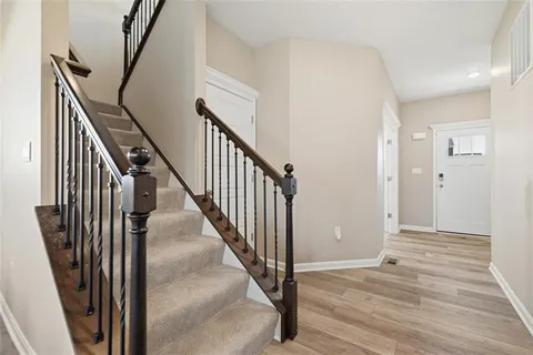 a view of an entryway with wooden floor