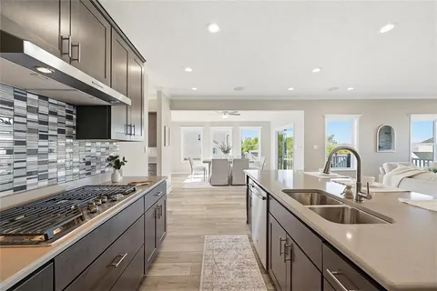 a kitchen with sink stove and cabinets