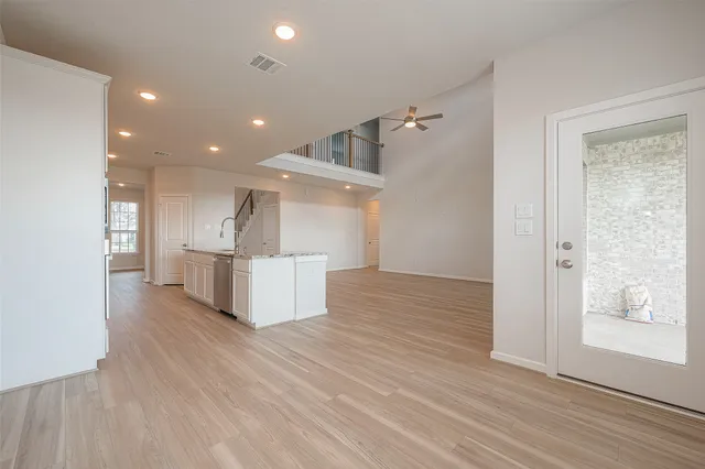 a view of kitchen with wooden floor and electronic appliances
