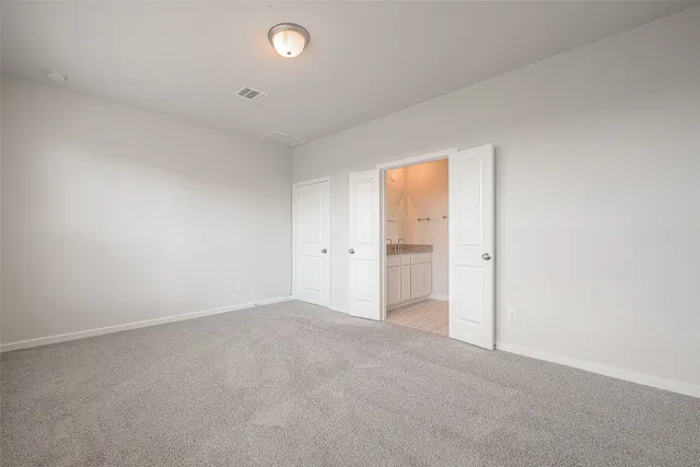 an empty room with an entryway and window
