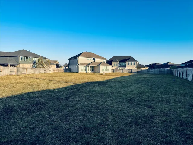 a view of a yard with a house in the background