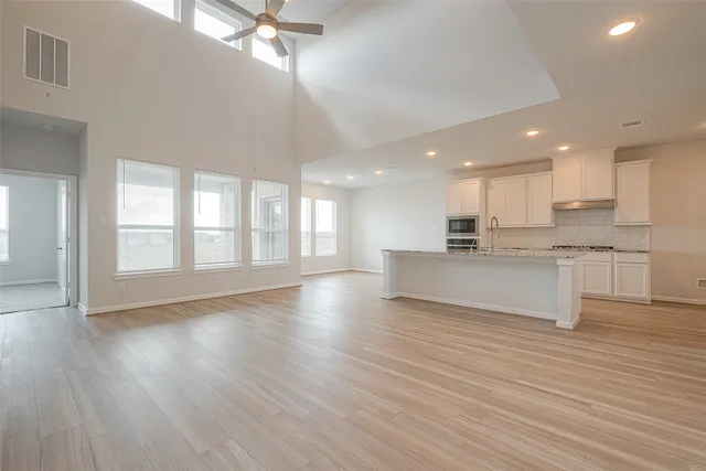 a view of kitchen with granite countertop stainless steel appliances sink and cabinets