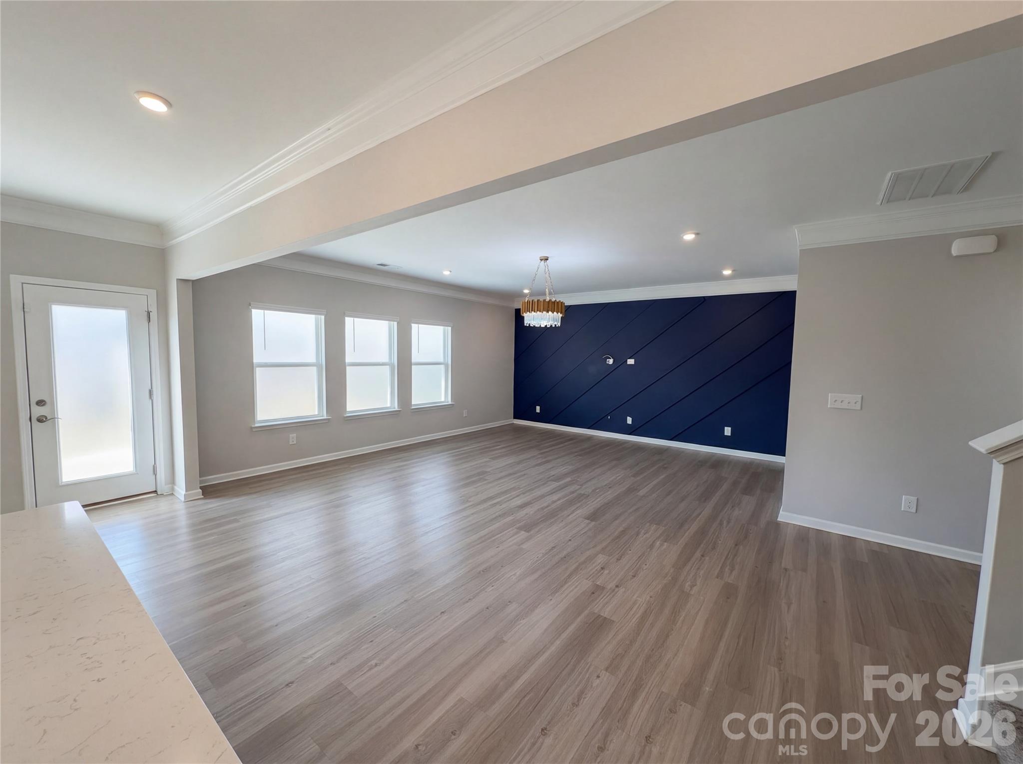 617 Ardsley Drive Locust, NC 28097 - Photo 3 of 23 an empty room with wooden floor and windows