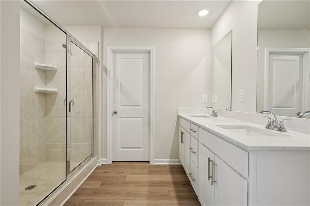 1458 High Fls Lane Grayson, GA 30017 - Photo 27 of 42 a bathroom with a double vanity sink and a mirror