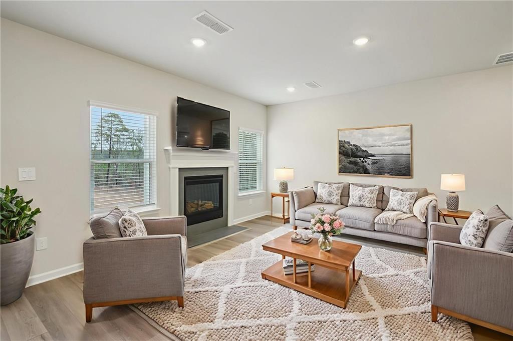 1458 High Fls Lane Grayson, GA 30017 - Photo 7 of 42 a living room with furniture flat screen tv and a fireplace