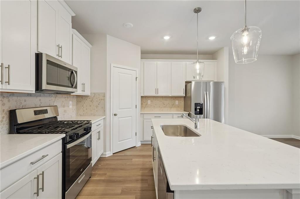 1458 High Fls Lane Grayson, GA 30017 - Photo 8 of 42 a kitchen with granite countertop a sink a counter space stainless steel appliances and cabinets