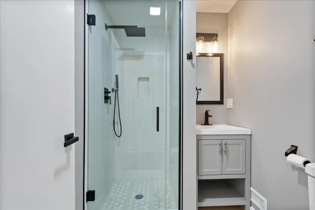 a bathroom with a shower and a sink