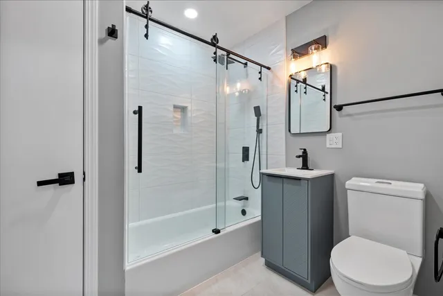 a bathroom with a shower a toilet and sink