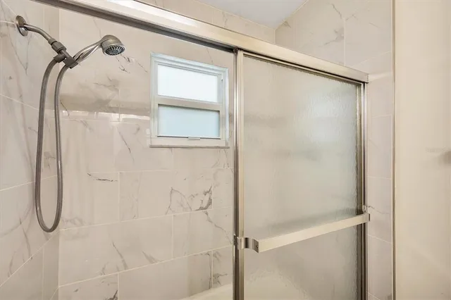 a bathroom with a glass shower door