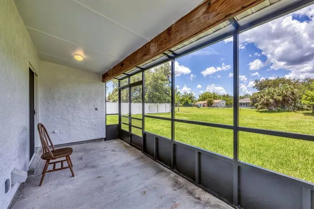 a view of a house with brick walls and a yard with plants
