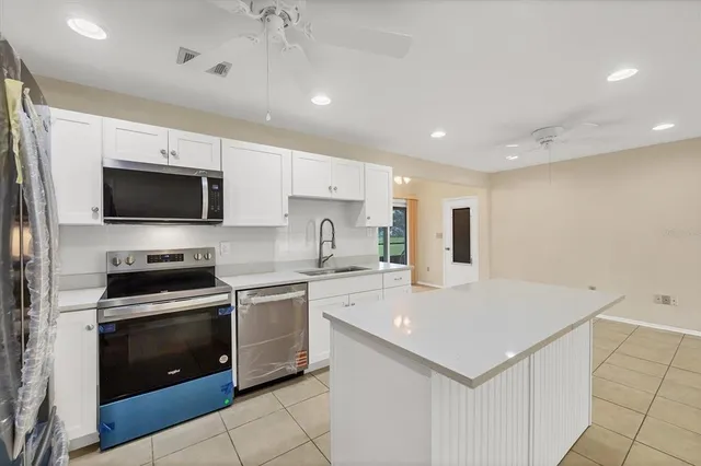 a kitchen with a stove a sink and a microwave