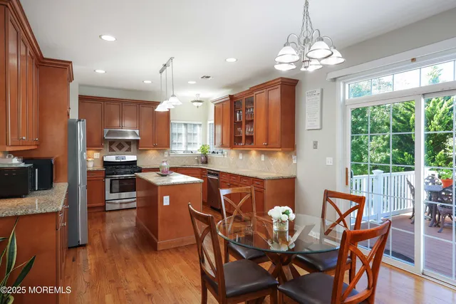 a large kitchen with a table and chairs