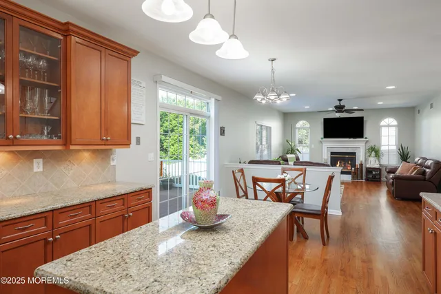 a kitchen with sink refrigerator dining table and chairs