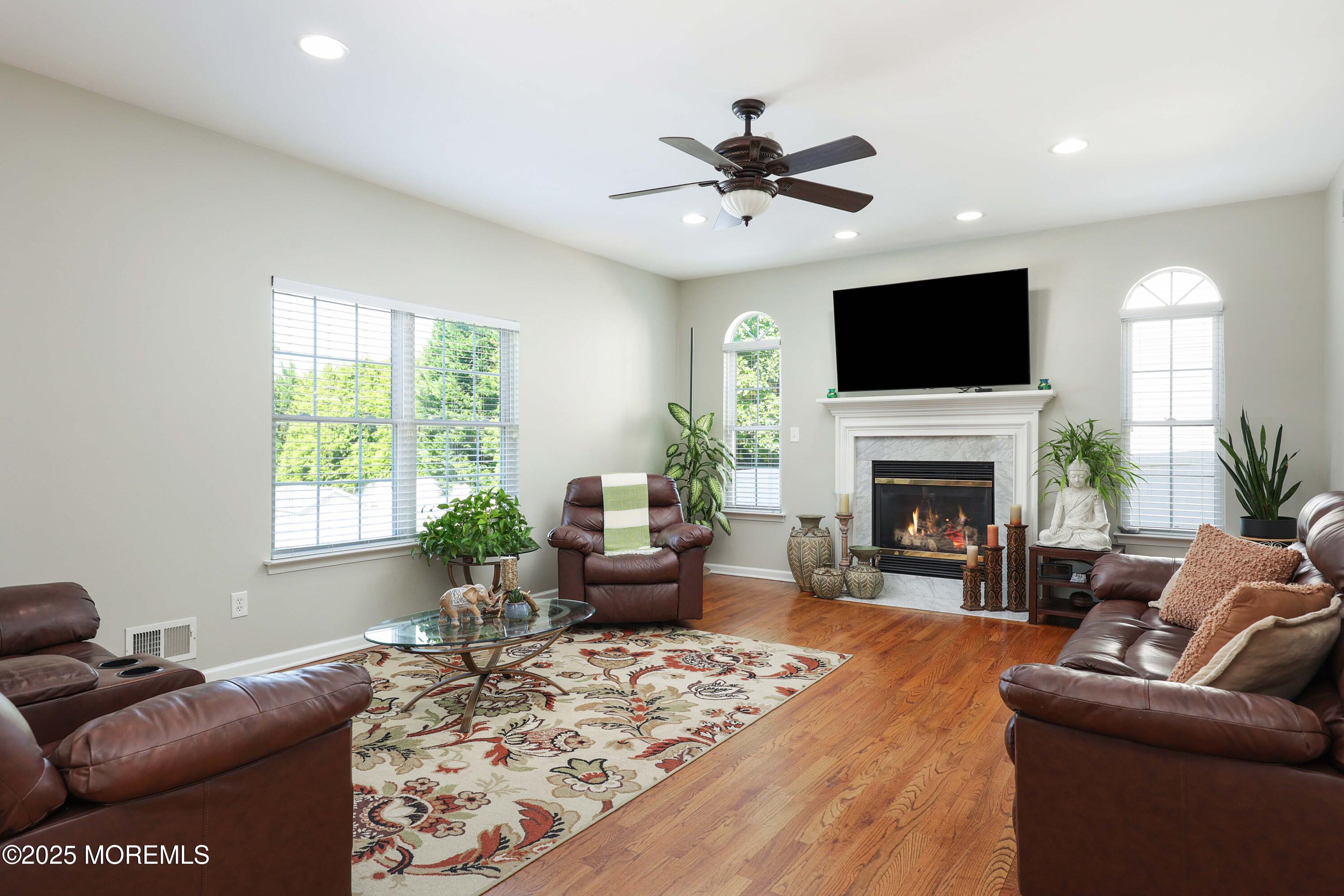 1 Boyd Road Hazlet, NJ 07730 - Photo 18 of 52 a living room with furniture a flat screen tv and a fireplace