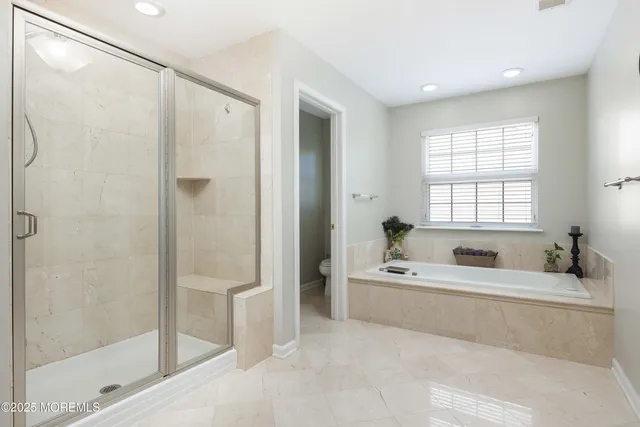 a bathroom with a tub a sink and a shower