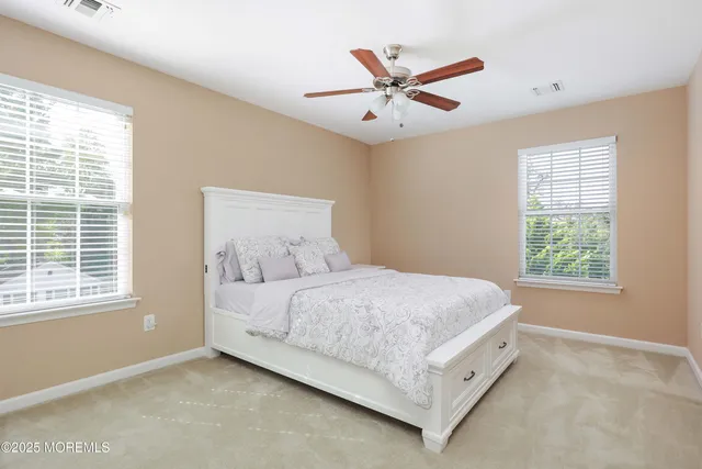 a bedroom with a bed a window and a chandelier