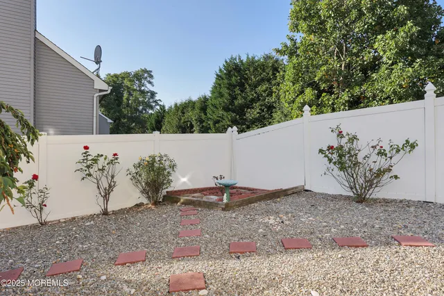 a view of a house with a yard and potted plants