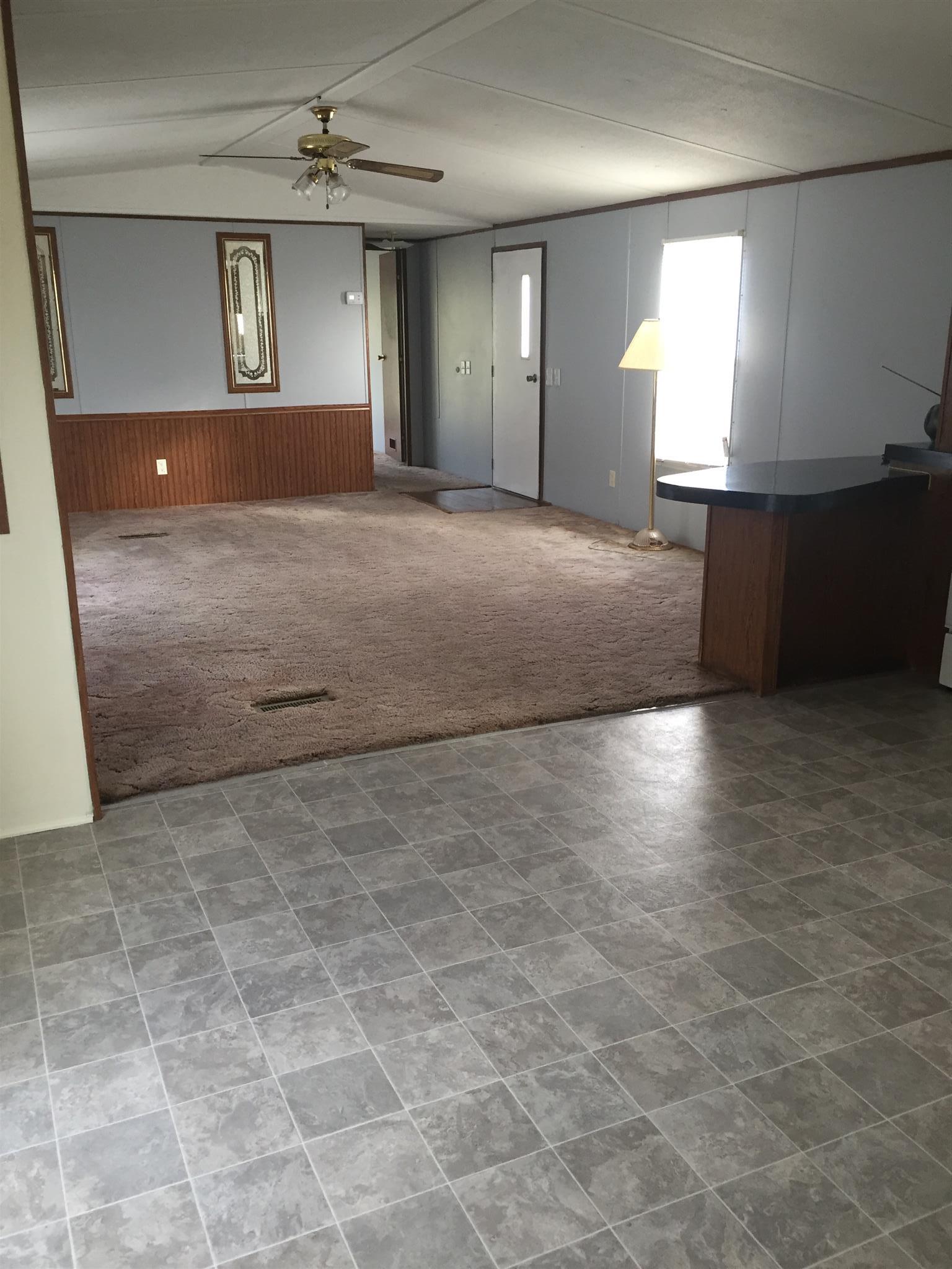 2175 Baggett Road Palmyra, TN 37142 - Photo 4 of 19 an empty room with kitchen view and windows
