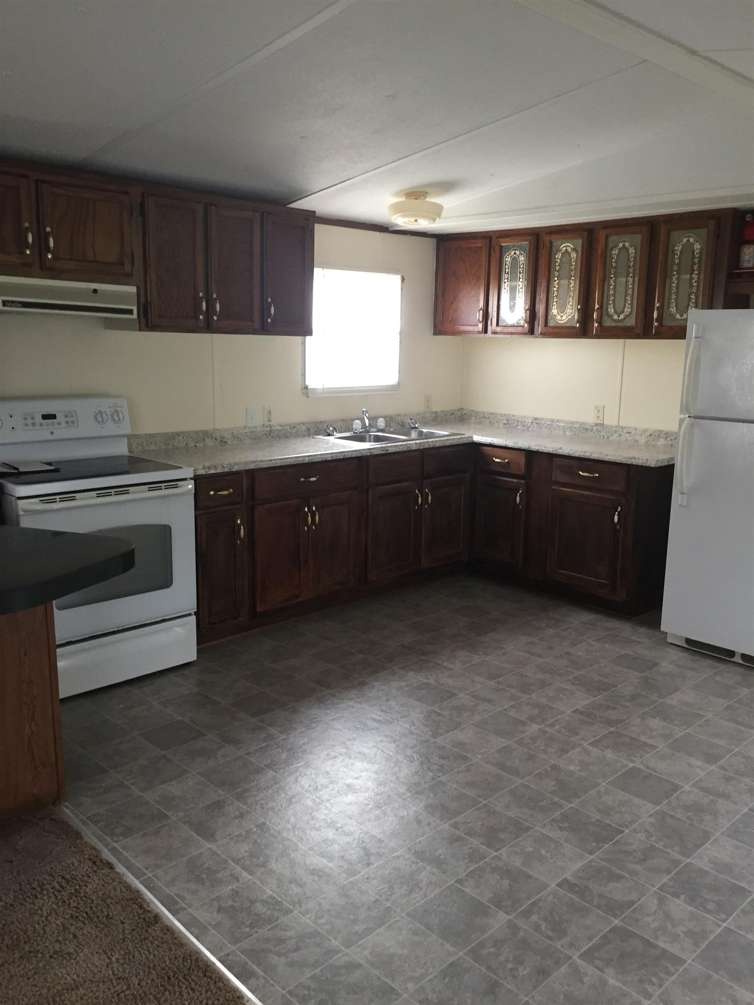 2175 Baggett Road Palmyra, TN 37142 - Photo 7 of 19 a kitchen with granite countertop a stove a sink dishwasher and a microwave oven with cabinets