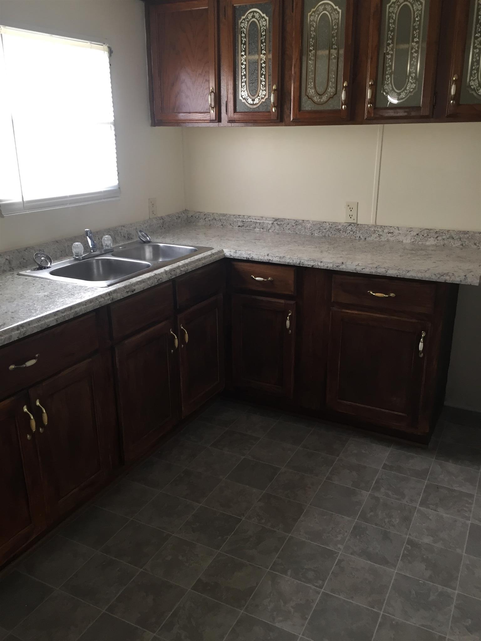 2175 Baggett Road Palmyra, TN 37142 - Photo 8 of 19 a kitchen with a sink and cabinets