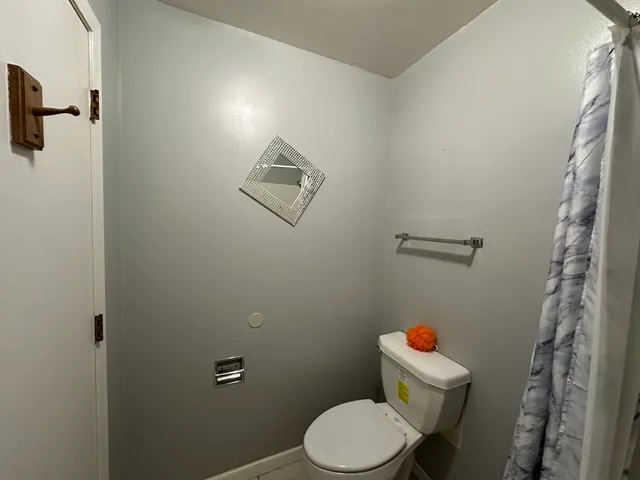 a white toilet sitting next to a bathroom sink