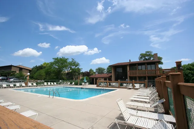 a view of swimming pool with outdoor seating and a pathway