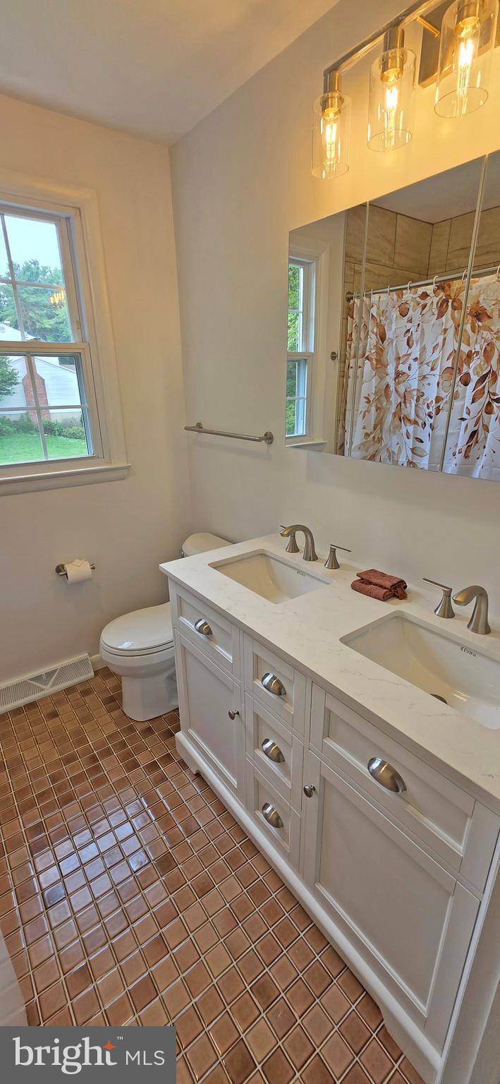 1900 Shetland Road Finksburg, MD 21048 - Photo 28 of 32 a bathroom with a granite countertop sink mirror vanity and toilet
