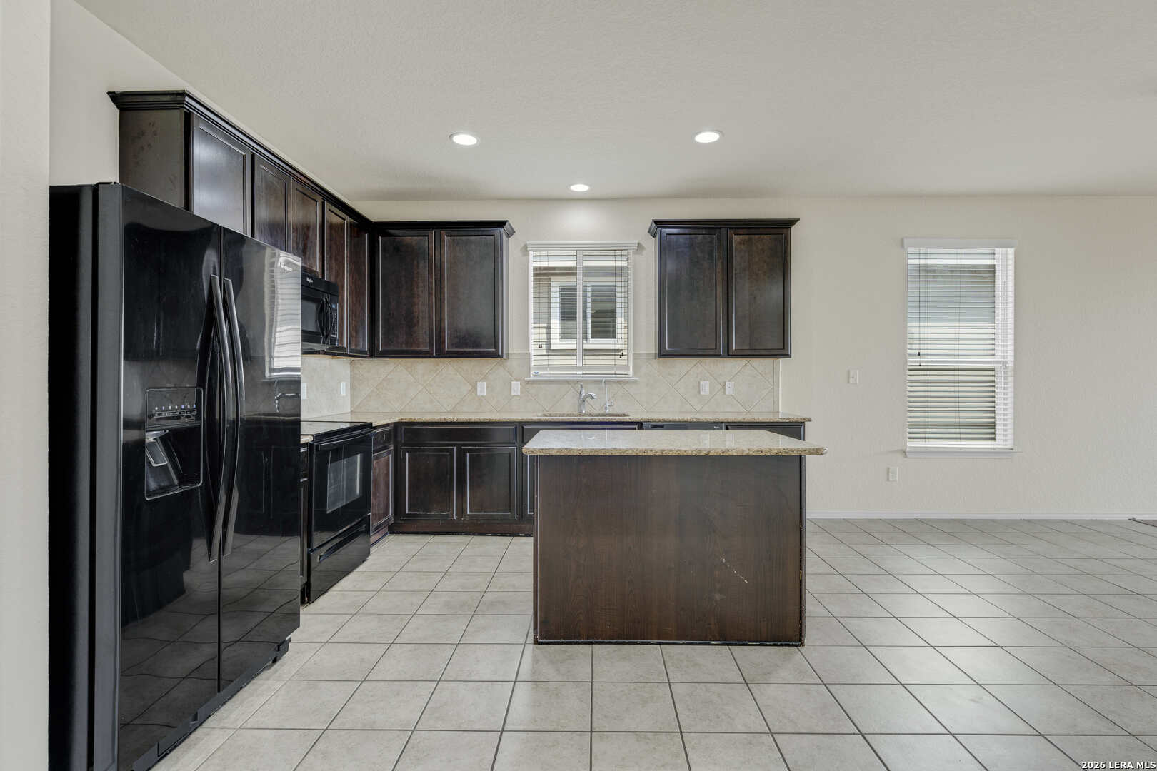 322 Walnut Crest Selma, TX 78154 - Photo 8 of 33 a kitchen with granite countertop a refrigerator and a sink