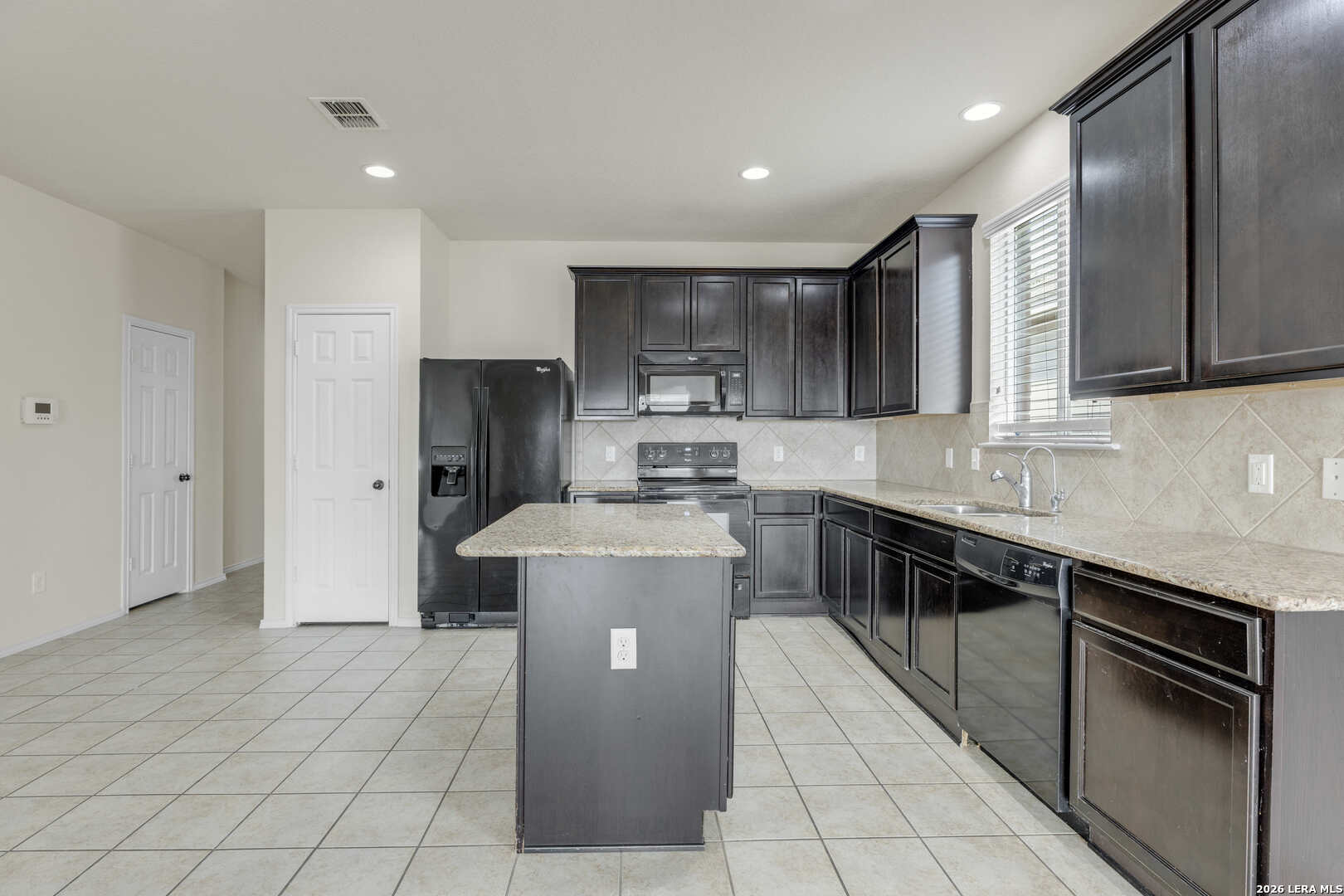 322 Walnut Crest Selma, TX 78154 - Photo 10 of 33 a kitchen with stainless steel appliances granite countertop a stove a sink and a refrigerator