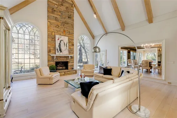a living room with furniture and floor to ceiling windows