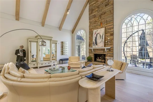 a dining room with furniture a chandelier and fireplace