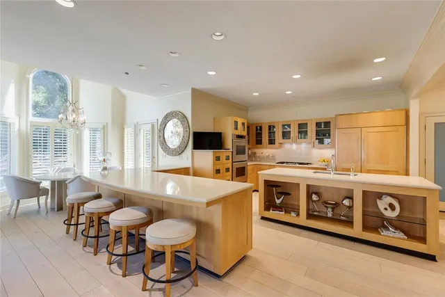 a large white kitchen with a large window