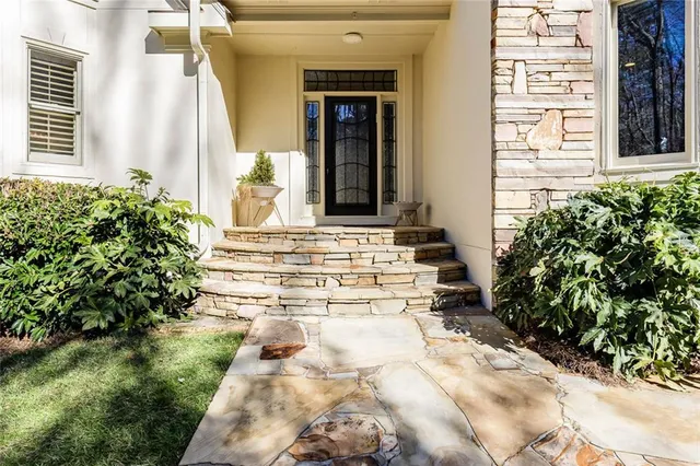 a living room with fireplace furniture and a large window