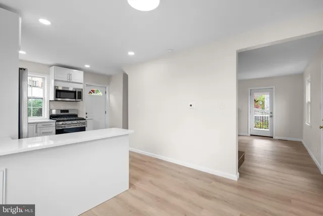 a large kitchen with a large counter top appliances and cabinets